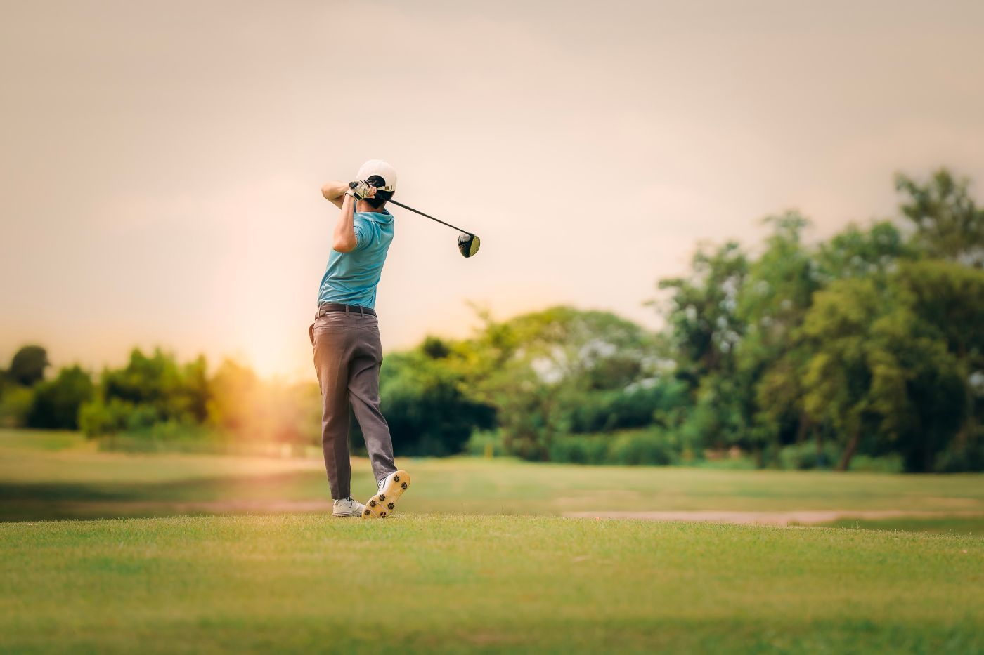 Golfer teeing off